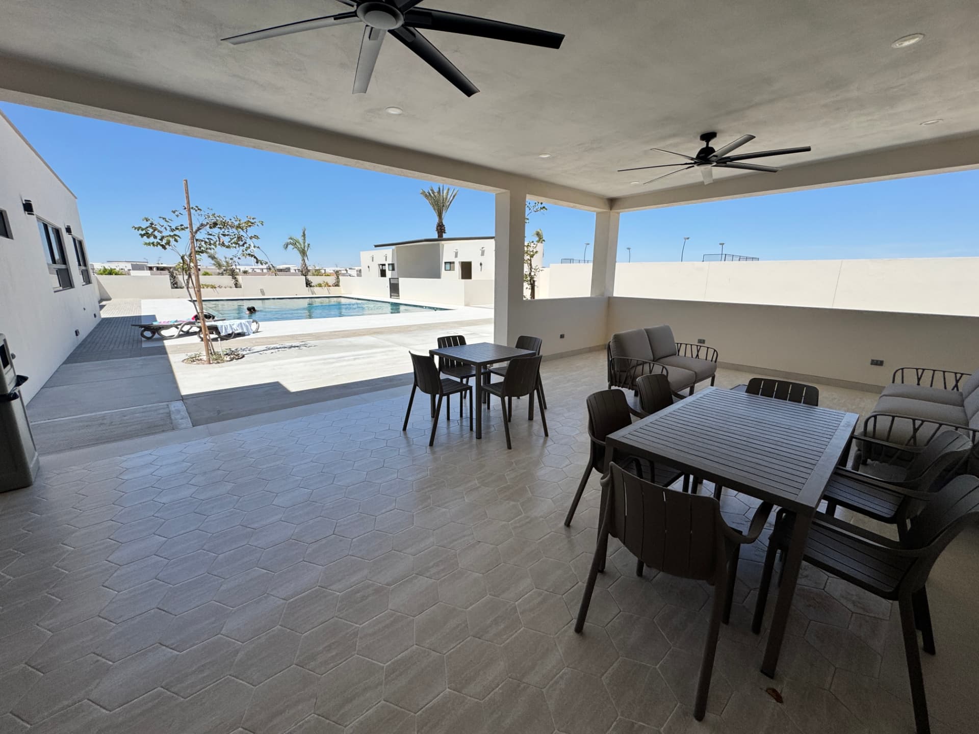 Community pool and covered patio at Viviente